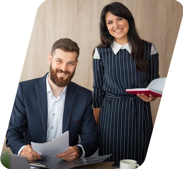 A small business owner smiling while reviewing financial reports with BooksMerge
